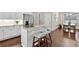 Modern kitchen with white cabinets, stainless steel appliances, and a breakfast bar overlooking the dining area at 10 Berryhill Se Pl, Cartersville, GA 30121