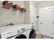 Functional laundry room with modern appliances, shelving, and storage space at 10 Berryhill Se Pl, Cartersville, GA 30121