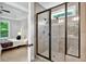 Frameless glass shower with bench, showerhead, handheld shower, and view into a bedroom at 10 Berryhill Se Pl, Cartersville, GA 30121