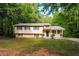 Charming, tree-surrounded split-level home with a freshly mowed yard at 1034 Sandy Ridge Rd, Mcdonough, GA 30252
