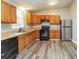 The renovated kitchen features wood cabinets, black appliances, and modern flooring at 1034 Sandy Ridge Rd, Mcdonough, GA 30252