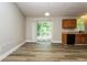 Open-concept living and dining area with modern flooring and deck access at 1034 Sandy Ridge Rd, Mcdonough, GA 30252