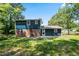 Backyard of home with grassy yard, patio, and trees under a sunny sky at 10664 Sandpiper Rd, Jonesboro, GA 30238