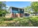 Back exterior of a two story home with a brick foundation and blue siding on a grassy lawn at 10664 Sandpiper Rd, Jonesboro, GA 30238