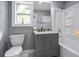 Contemporary bathroom with gray vanity, marble countertop, modern toilet, and shower/tub combo at 10664 Sandpiper Rd, Jonesboro, GA 30238