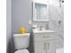 Bathroom with stylish vanity, marble walls, shower, and toilet at 10664 Sandpiper Rd, Jonesboro, GA 30238