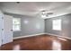 This bedroom features wood floors, one window, and gray walls at 10664 Sandpiper Rd, Jonesboro, GA 30238
