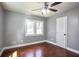 Cozy bedroom features hardwood floors, a ceiling fan, neutral paint, and trim at 10664 Sandpiper Rd, Jonesboro, GA 30238