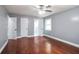 This bedroom features wood floors, two doors, and gray walls at 10664 Sandpiper Rd, Jonesboro, GA 30238