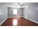 This bedroom features wood floors, one window, and gray walls at 10664 Sandpiper Rd, Jonesboro, GA 30238