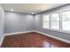 Bright bedroom with hardwood floors, fresh paint, and natural light from the windows at 10664 Sandpiper Rd, Jonesboro, GA 30238