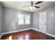 This bedroom features wood floors, a ceiling fan, and gray walls at 10664 Sandpiper Rd, Jonesboro, GA 30238