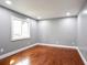 Empty bedroom with hardwood floors, neutral walls, trim and a large window at 10664 Sandpiper Rd, Jonesboro, GA 30238
