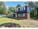 Charming two-story home featuring a blue and brick exterior, well-manicured front lawn, and covered front porch at 10664 Sandpiper Rd, Jonesboro, GA 30238