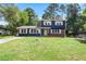 Charming two-story home with a brick and blue exterior, white trim, a well-maintained lawn, and a welcoming front entrance at 10664 Sandpiper Rd, Jonesboro, GA 30238