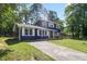 Charming two-story home featuring a blue and brick exterior, well-manicured front lawn, and paved driveway at 10664 Sandpiper Rd, Jonesboro, GA 30238