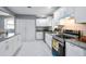 Stylish kitchen with white cabinets, granite countertops, stainless steel appliances, and marble floors at 10664 Sandpiper Rd, Jonesboro, GA 30238