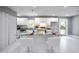 Modern kitchen featuring white cabinets, granite countertops, a center island, and sleek white bar stools at 10664 Sandpiper Rd, Jonesboro, GA 30238
