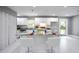 Spacious kitchen featuring a center island, white cabinets, marble flooring, and modern appliances at 10664 Sandpiper Rd, Jonesboro, GA 30238