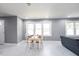 Sunlit open-concept living room with modern flooring, dining space, and access to other living areas at 10664 Sandpiper Rd, Jonesboro, GA 30238