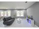 Modern living room with recessed lighting, marble-look floors, neutral grey walls, and a comfortable sofa at 10664 Sandpiper Rd, Jonesboro, GA 30238