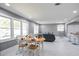 Open-concept living and dining area with recessed lighting, marble-look flooring, and large windows at 10664 Sandpiper Rd, Jonesboro, GA 30238