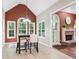 Cozy dining area with modern lighting, hardwood floors, large windows, and an archway that connects to the living room at 2297 Herring Woods Way, Grayson, GA 30017