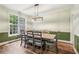 Formal dining room with elegant lighting, hardwood floors, decorative molding, and large window offering bright light at 2297 Herring Woods Way, Grayson, GA 30017