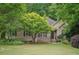 Charming brick home with lush landscaping, mature trees, and a well-manicured lawn creating a welcoming curb appeal at 2297 Herring Woods Way, Grayson, GA 30017