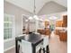Open concept kitchen with breakfast bar, stainless steel appliances, tile backsplash, and views into the living areas at 2297 Herring Woods Way, Grayson, GA 30017