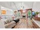 Bright living room with vaulted ceiling, fireplace, wood floors, and large windows that offers lots of natural light at 2297 Herring Woods Way, Grayson, GA 30017