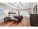 Spacious main bedroom with hardwood floors, large windows, tray ceiling and neutral decor at 2297 Herring Woods Way, Grayson, GA 30017