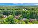 An aerial view shows a home nestled among trees in a quiet, lushly landscaped neighborhood at 2641 Loch Way, Snellville, GA 30039