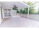 Spacious back deck with white lattice, fan, and a view of lush green trees and surrounding landscape at 2641 Loch Way, Snellville, GA 30039