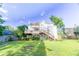 Beautiful backyard view showcasing a two-story home with a back deck, a porch, and lush green grass at 2641 Loch Way, Snellville, GA 30039