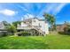 Expansive, grassy backyard includes a deck, a patio, mature trees, and lush landscaping at 2641 Loch Way, Snellville, GA 30039