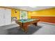 A view of the basement with a billiards table, white doors, and one window at 2641 Loch Way, Snellville, GA 30039