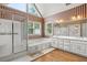Bathroom with a shower, tub, and double sink vanity with ample lighting at 2641 Loch Way, Snellville, GA 30039