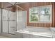 Bathroom featuring a tile shower and a soaking tub with natural light from windows at 2641 Loch Way, Snellville, GA 30039