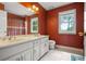 Bathroom with a double sink vanity, and shower behind a curtain at 2641 Loch Way, Snellville, GA 30039