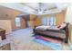 Large bedroom with neutral colors, tray ceilings, a ceiling fan and a window at 2641 Loch Way, Snellville, GA 30039