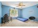 This bedroom has blue walls and carpeted floors with a window offering natural light at 2641 Loch Way, Snellville, GA 30039