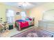 Bright bedroom features a comfortable bed, ample natural light, and a stylish rug at 2641 Loch Way, Snellville, GA 30039