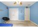 This bedroom has blue walls, a closet, and a small round chair on the carpeted floor at 2641 Loch Way, Snellville, GA 30039