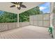 A covered deck features trellises, a ceiling fan, and a storage bench with wooded backyard views at 2641 Loch Way, Snellville, GA 30039