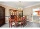 Lovely dining area featuring chandelier lighting, wood furniture, and seamless access to kitchen at 2641 Loch Way, Snellville, GA 30039