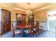 Formal dining room with classic chandelier, wood furniture, and crown molding at 2641 Loch Way, Snellville, GA 30039