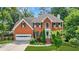 Beautiful two-story brick home with lush landscaping and a well-manicured lawn at 2641 Loch Way, Snellville, GA 30039