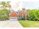 Charming two-story brick home featuring a manicured lawn and a spacious driveway at 2641 Loch Way, Snellville, GA 30039