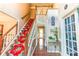 Elegant foyer with hardwood floors, staircase with carpet runner, and decorative accents at 2641 Loch Way, Snellville, GA 30039